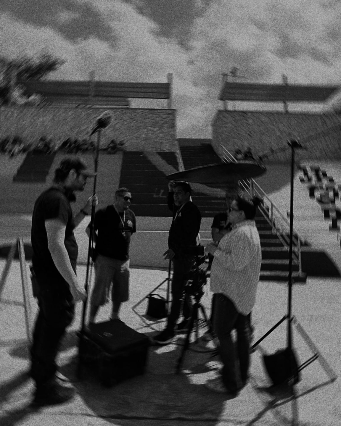 Film crew preparing an interview in a stadium